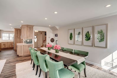 Dining room with green chairs and leaf paintings-1