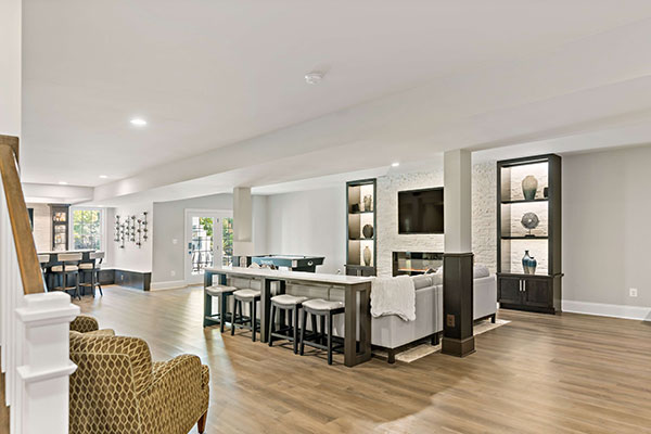 Stunning Haymarket Basement Remodel Showcases Welcoming Wet Bar and Cozy Fireplace  